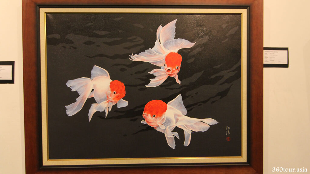 The painting of three Lionhead Goldfish in water. The great contrast and refection painting makes it appears to be readily swimming.
