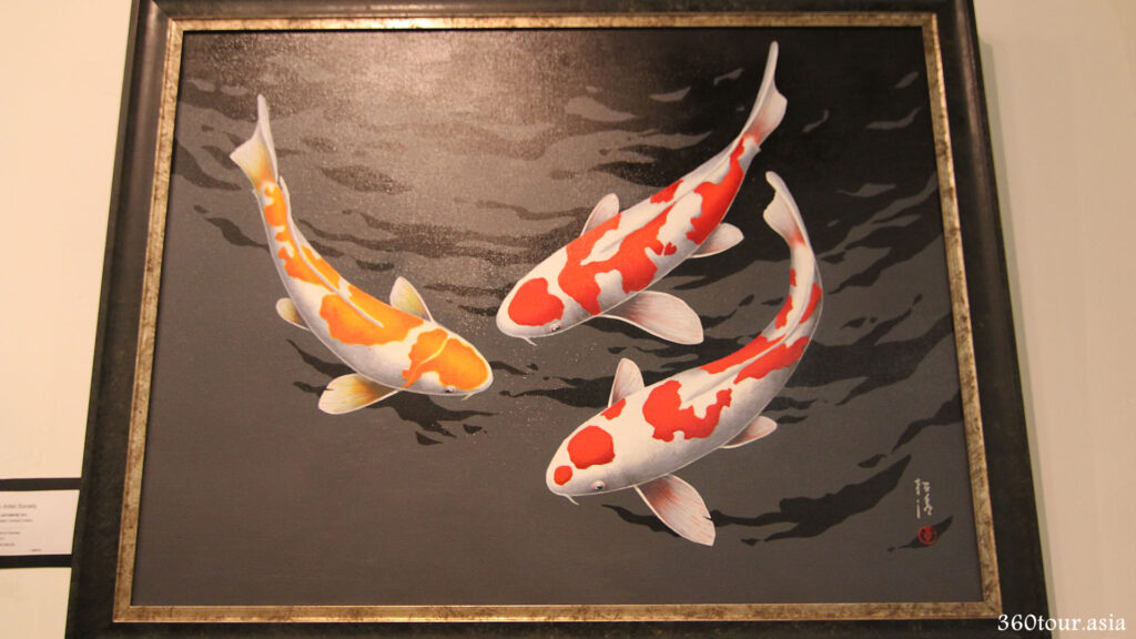 The painting of three Japanese Koi fish in water. The great contrast and refection painting makes it appears to be readily swimming.