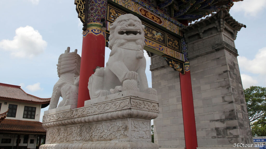 Chinese Guardian Lions at the Chinese Gateway of Friendship Park. This male Guardian Lion holding a embroidered ball