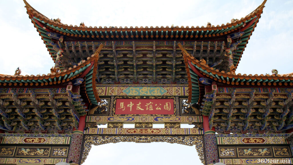 The close up view of Chinese Gateway features colorful beams with Chinese motifs, finely carved arch ornaments and the curve roofs