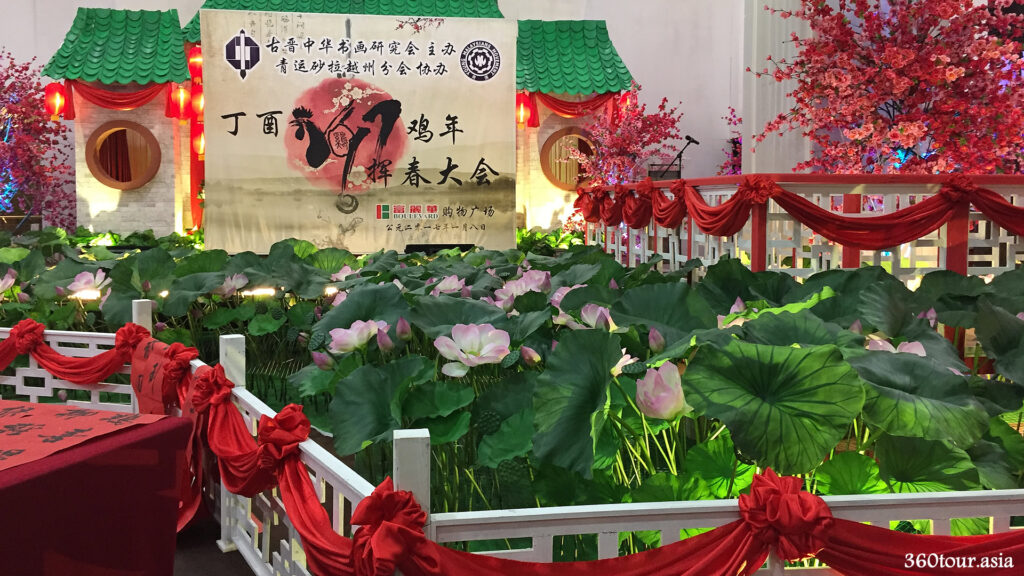 The lotus flower blossoms , Zig Zag bridge, Garden Pavilion, red ribbons, Curved Ceramic roof tiles, Round windows