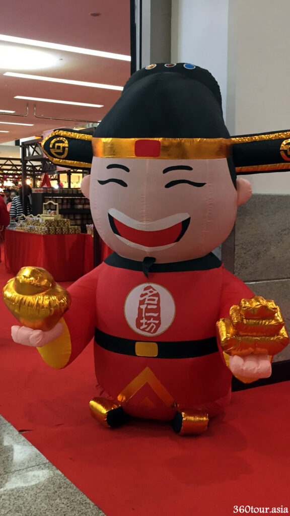 The life sized inflatable figure of the god of prosperity holding gold bars and ingots