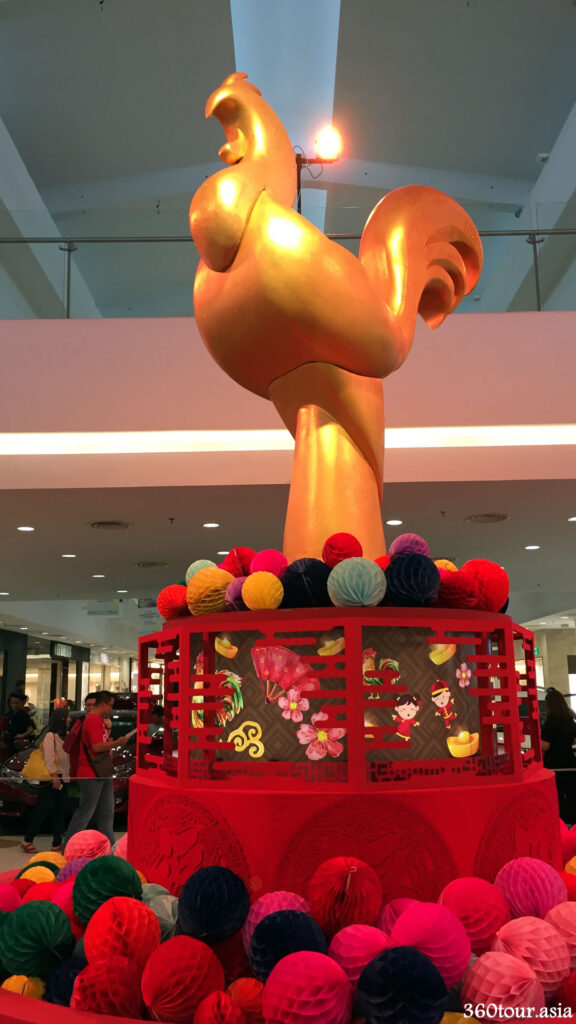The massive chicken replica standing at the center court, on a rotating base