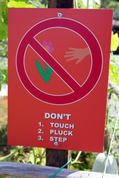 Signage warning visitors not to touch, pluck and step on the plants