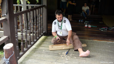 Outside the Rainforest Music House there is demonstration on how to make a Boat Lute - Sape