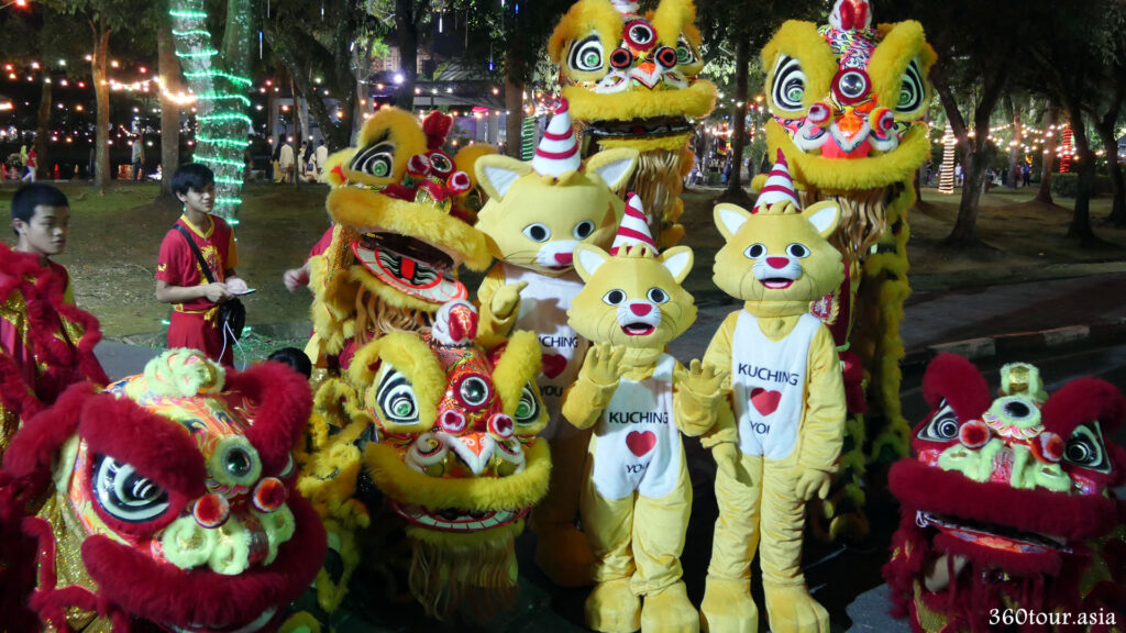 Taking photos with the Lion Dance and Kuching Fest mascot