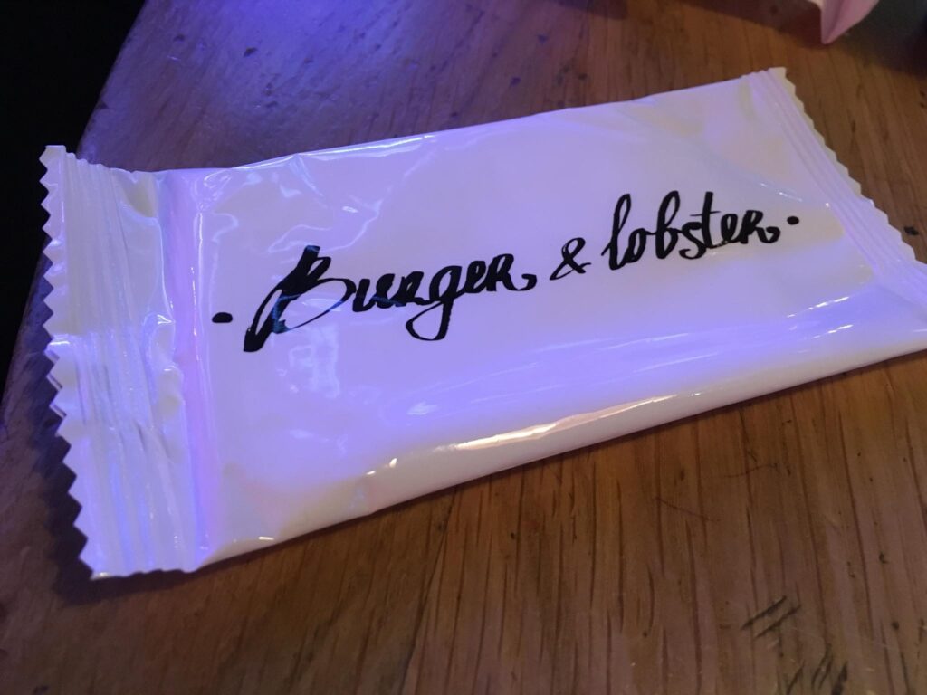 The Burger &amp; Lobster specially designed wet tissue package