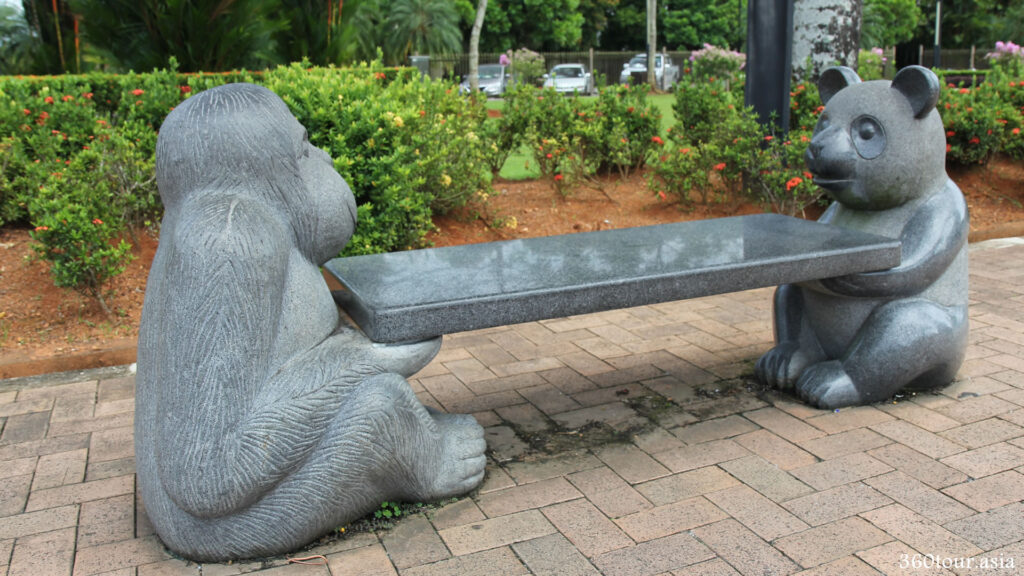 The Orang Utan and The Panda granite statue holding the connecting plank to form a garden chair