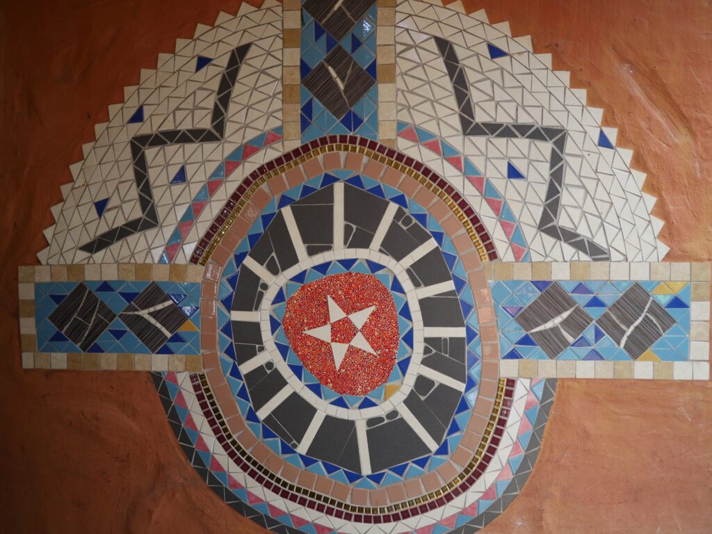 The decorative tile mural on the wall