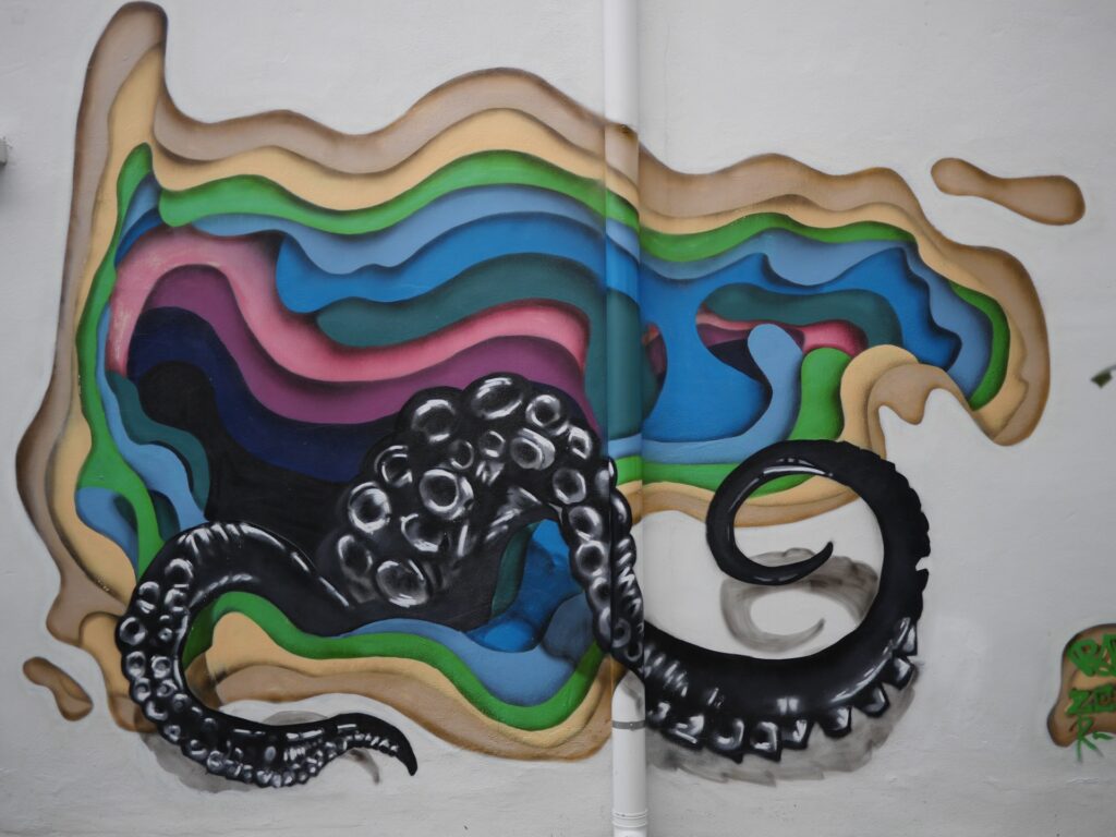 3D Mural is imaginary, from a distorted colorful dimension opening , there raised two huge black tentacles try to breach the opening