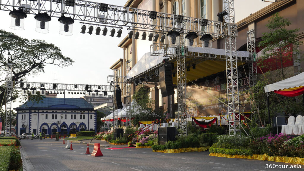 In front of the grand stage at Plaza Merdeka