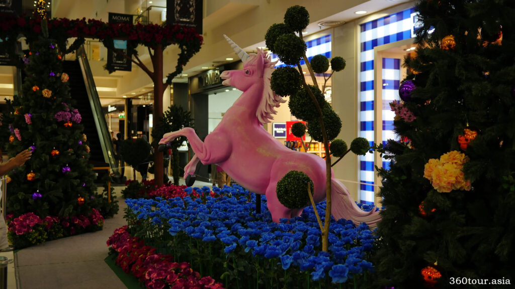 The Pink Unicorn on the group of blue flowers