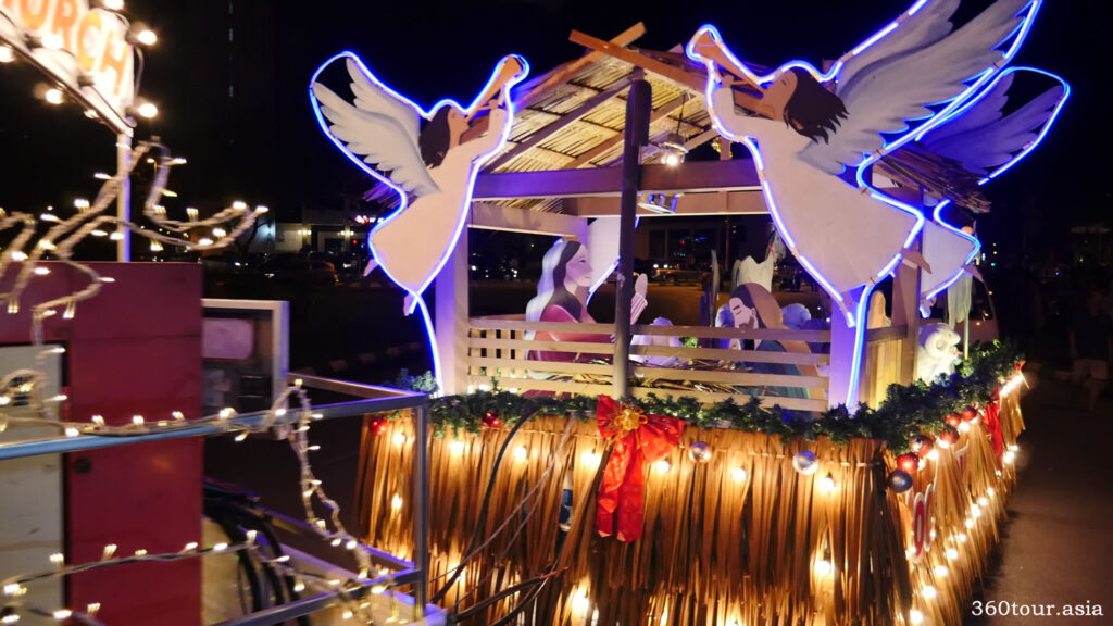 The Christmas float featuring angles around the stable