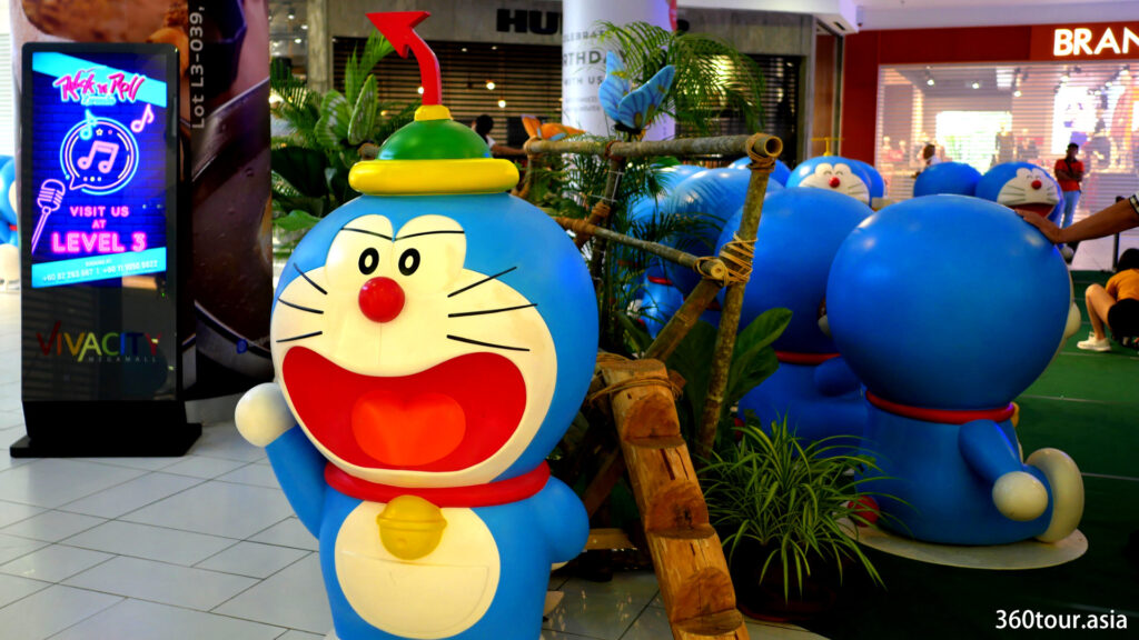 The doraemon statue beside a traditional wooden stairs