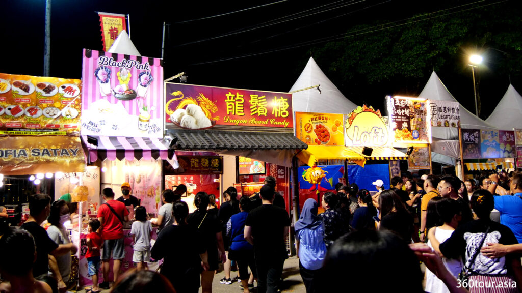 People gather around the food stalls.