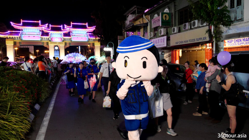 The mascot of the brigade team marching on the city streets.