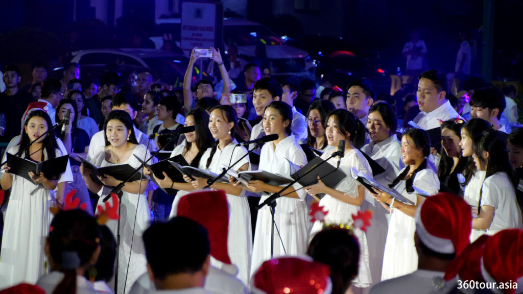 The singing of the Christmas Carol Choir.