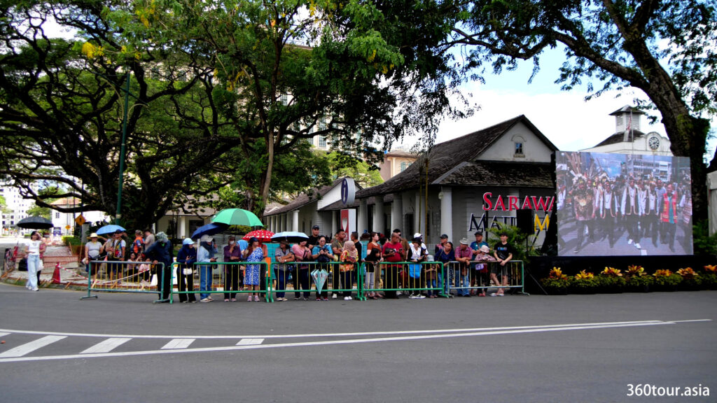 People gathering along the street to witnessing the parade.
